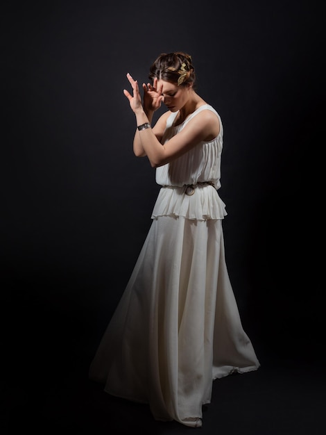 Heroine of an ancient tragedy in grief and loss A young woman in a white tunic