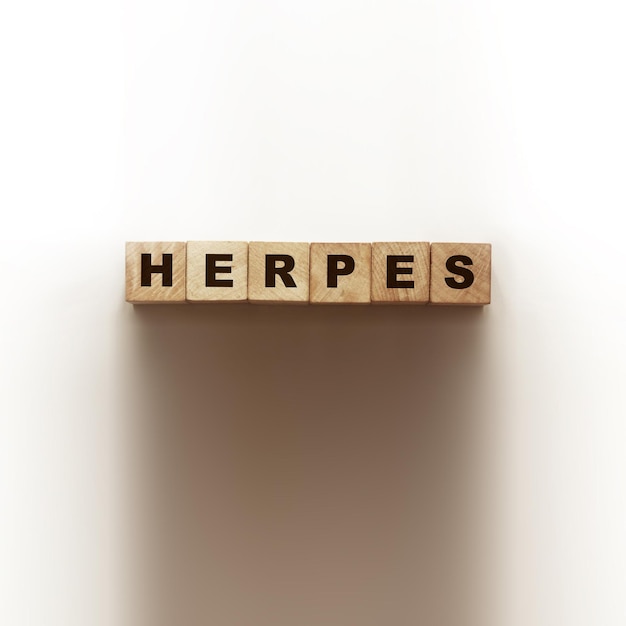 HERPES word made with wooden blocks on white Healthcare concept