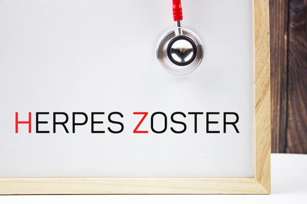 HERPES ZOSTER text on a chalkboard next to a stethoscope