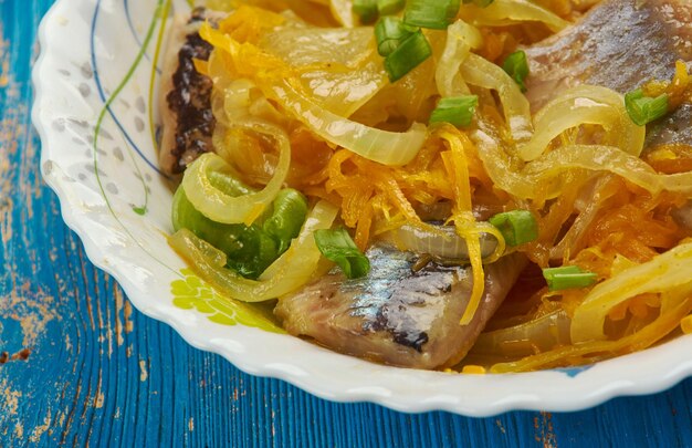 Herring in carrot and onion marinade, close up