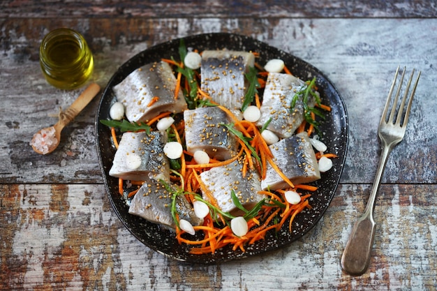 Herring fillet pieces marinated with spices on a plate