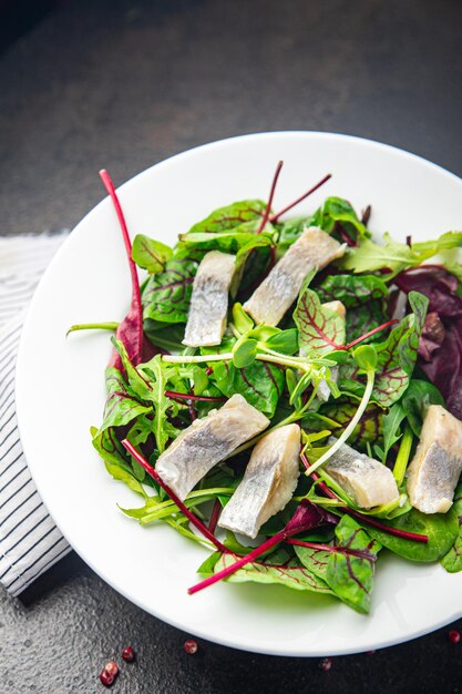 Herring salad fish slices seafood green mix leaf lettuce ready to eat fresh portion healthy meal