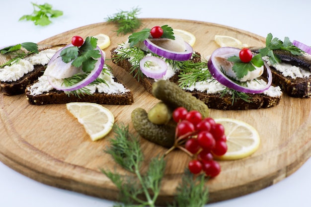 herring sandwiches on wooden Board