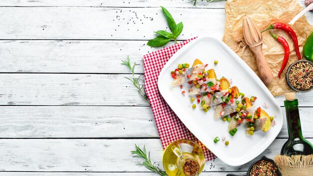 Herring with baked potatoes on a plate Restaurant dishes Top view Free space for your text