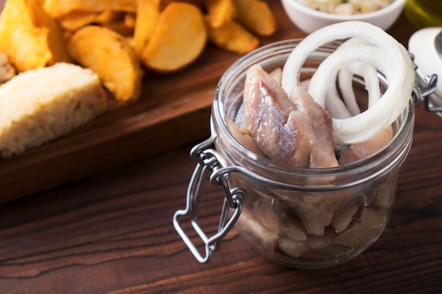 Herring with onion in a glass jar