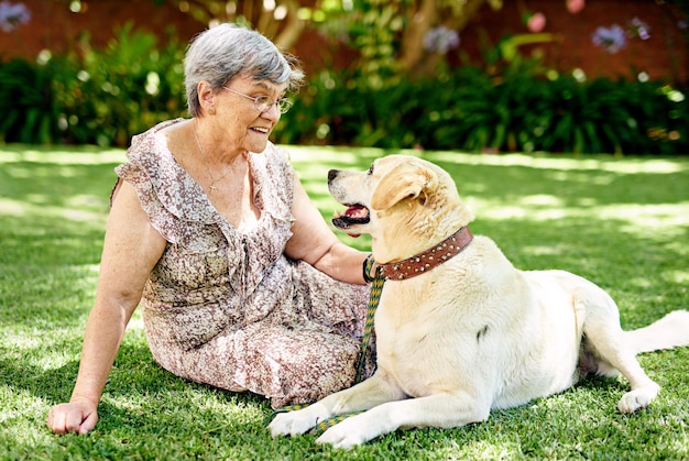 Hes been my companion for years Shot of a senior woman sitting outside with her dog