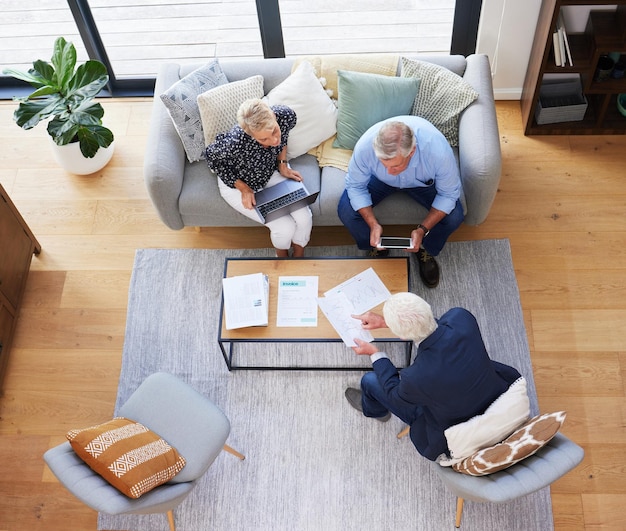 Hes got all the data you need Aerial shot of a group of businesspeople going through paperwork