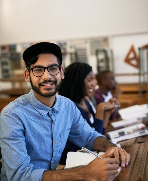 Hes happy about the task they received Portrait of an university student sitting in class