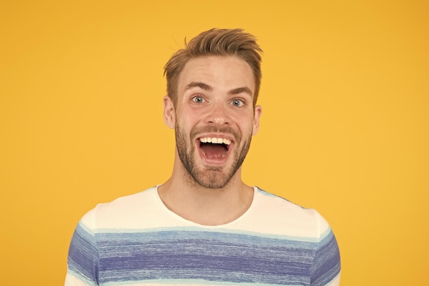 hes really fun and happy happy man with big smile on yellow background handsome guy with beard and sexy smile on happy face quite happy being me