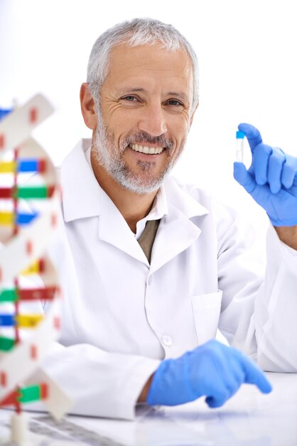 Hes a tenacious scientist Portrait of a mature male scientist holding a medical sample in his lab