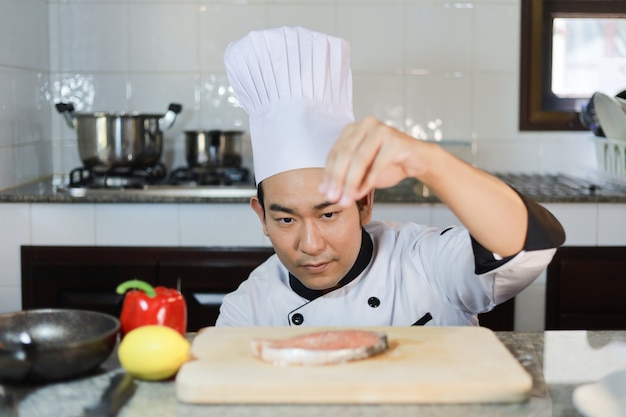 Het aziatische kokende voedsel van de mensenchef-kok in restaurant