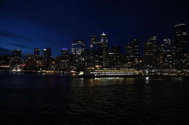 Foto het centrum van seattle van het water tegen de hemel's nachts.