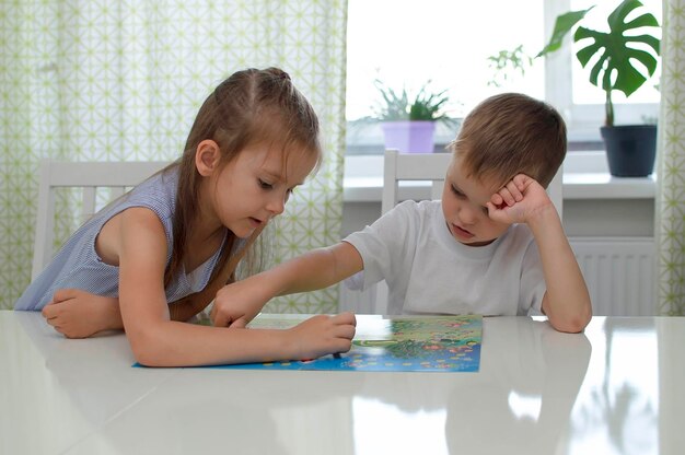 Het concept van een bordspel. kinderen vermaken zich thuis met bordspellen. een bordspelveld, veel stukken. het concept van een bordspel en vrije tijd voor kinderen.