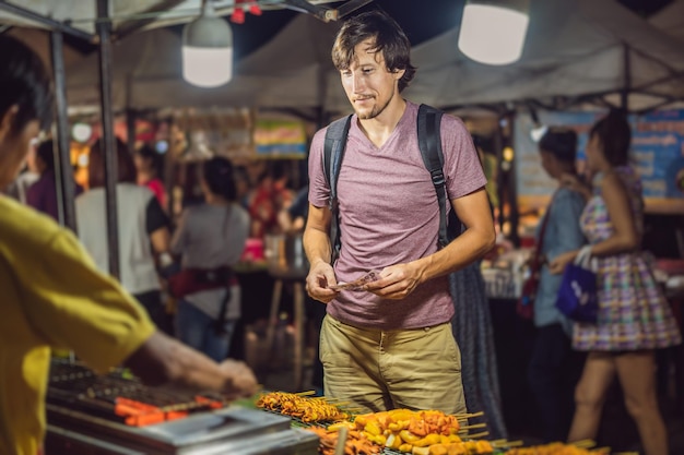 Foto het coronavirus is voorbij, de quarantaine is verzwakt, doe het masker af, nu kun je op straat lopen, aziatische voedselmarkt.