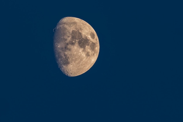 Het halfrond van de maan met een zichtbaar oppervlak en prachtige kraters aan de nachtelijke hemel