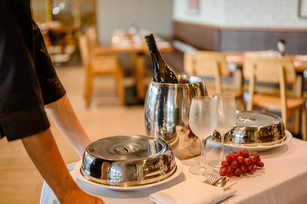 Het hotelpersoneel serveert een privédiner.roomservice.