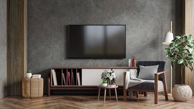 Foto het interieur van de woonkamer heeft een tv-kast en een fauteuil in een cementkamer met een betonnen muur. 3d-rendering