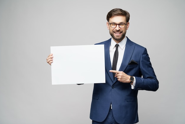 Het jonge lege teken van de zakenmanholding over grijze muur