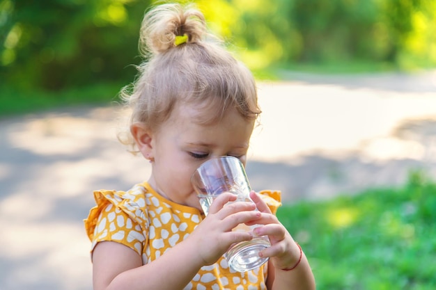 Het kind drinkt water uit een glas Selectieve focus