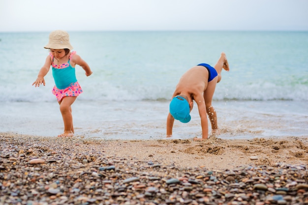 Het kind speelt en spettert in de zee