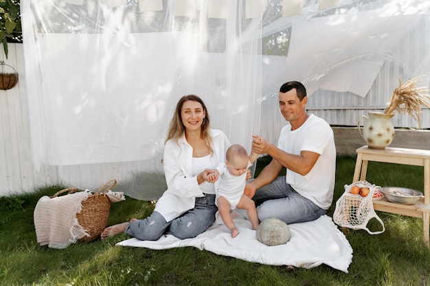 het kind speelt met zijn ouders in de tuin van het huis Wasserij