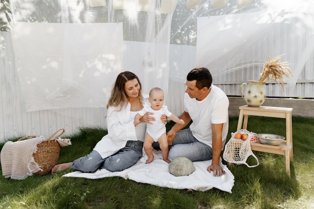 het kind speelt met zijn ouders in de tuin van het huis Wasserij