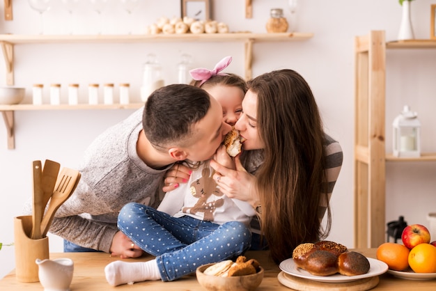 Het kind voedt ouders in de keuken