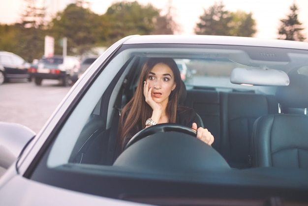 Het meisje in de auto staat in de file.