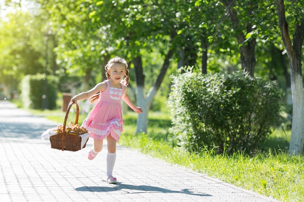 Het meisje rent langs de weg met een mand met brood.