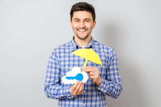 Het model van de jonge mensenholding van wolk met blauwe zeer belangrijke en gele paraplu