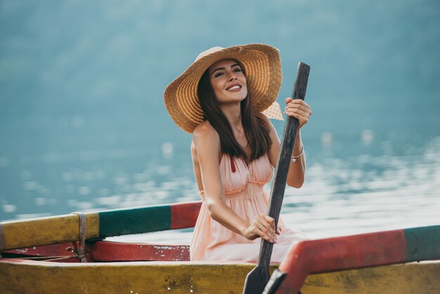 Het mooie meisje kayaking op de catamaran bij de bratan tempel van ulundatu pura, in bali