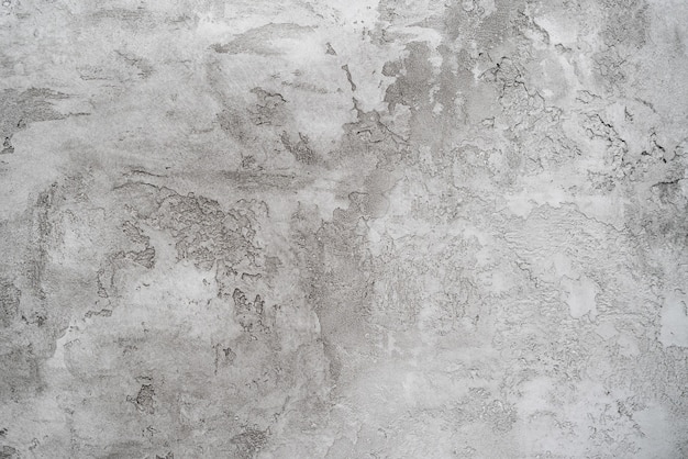 Het patroon van grijze gips op een witte muur.
