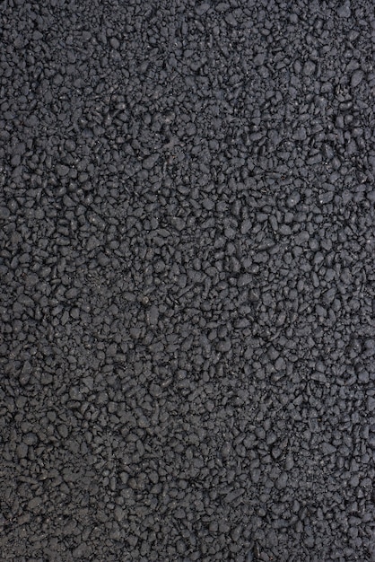 Het patroon van het zwarte asfalt. Weg oppervlak. Detailopname. Verticaal frame