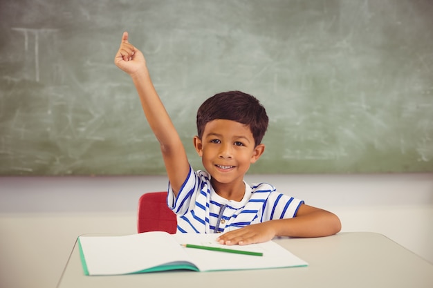 Het portret van schooljongen het opheffen dient klaslokaal in