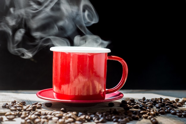 Het stomen van koffie rode kop en koffiebonen op hout