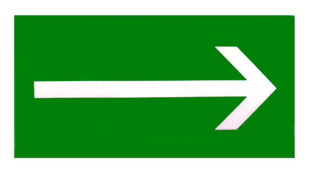 Het teken van de richting naar de evacuatie-uitgang op de muur in het winkelcentrum is groen