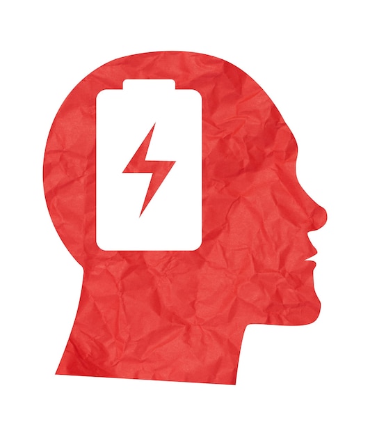 Het uitgekapte silhouet van een mannelijk hoofd en een batterij symbool in de hersenen het concept van psychische gezondheid depressie