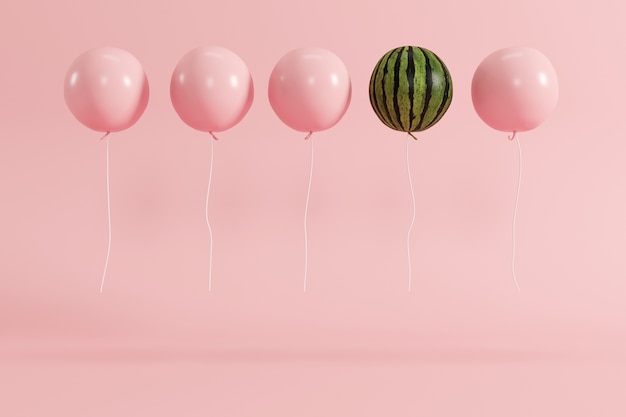 Het uitstekende concept van de ballonwatermeloen op pastelkleur roze achtergrond