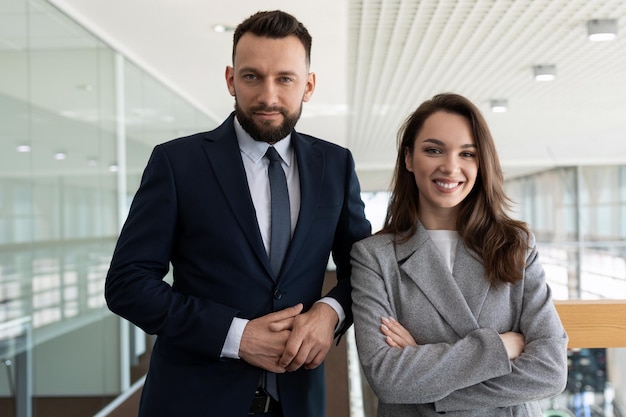 Photo heterosexual company executives in business suits against the backdrop of a modern stylish office