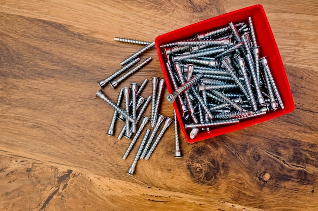 Hex bolts screw for furniture assembly on wooden background Top view