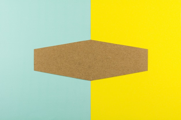 Hexagon brown paper on blue and yellow paper background