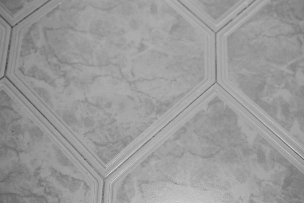 A hexagon tile floor with a white hexagon pattern.