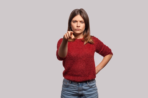 Hey you Portrait of angry bossy brunette woman in shaggy sweater pointing finger to camera