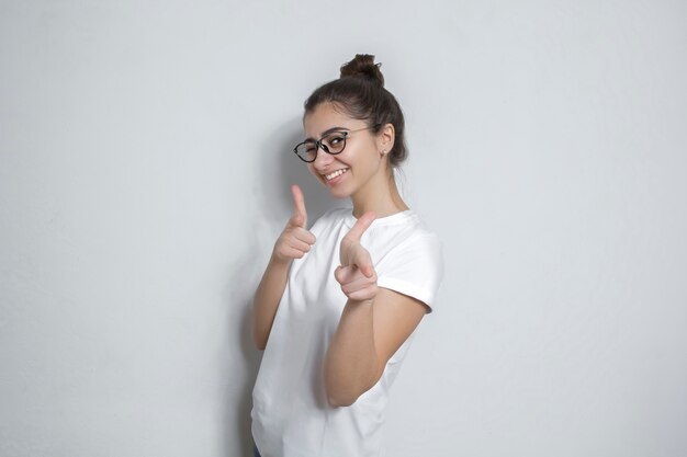 Hey you! Portrait of a beautiful woman pointing at you smiling