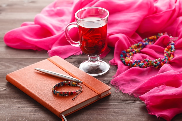 Hibiscus tea and pink silk shawl on table