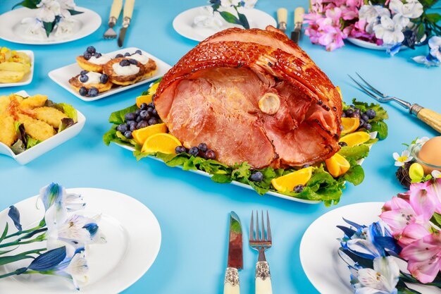 Hickory smoked ham on festive table. Easter dishes.