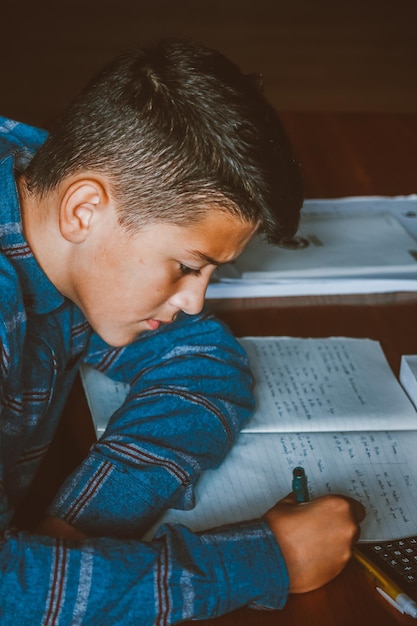 High angel view of boy writing in paper