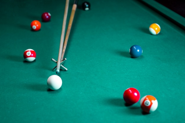 Photo high angle arrangement with pool cue and balls