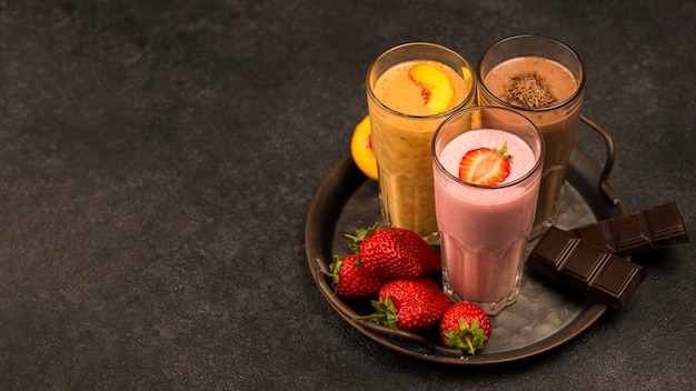 High angle of assortment of milkshakes with chocolate and copy space