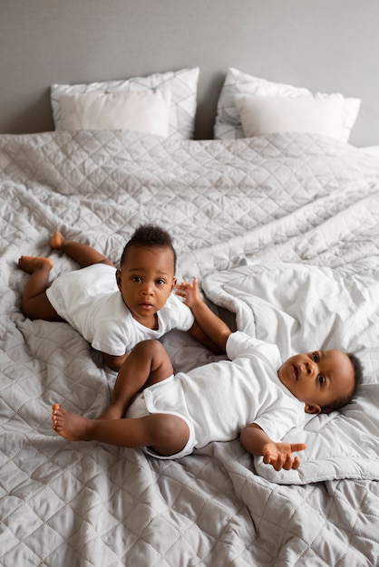 High angle babies laying in bed